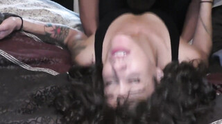 Geweldige vrouw met krullend haar spreidt de benen voor een zwarte man